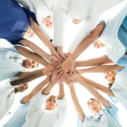 48353202 - directly below shot of multiethnic medical team stacking hands over white background